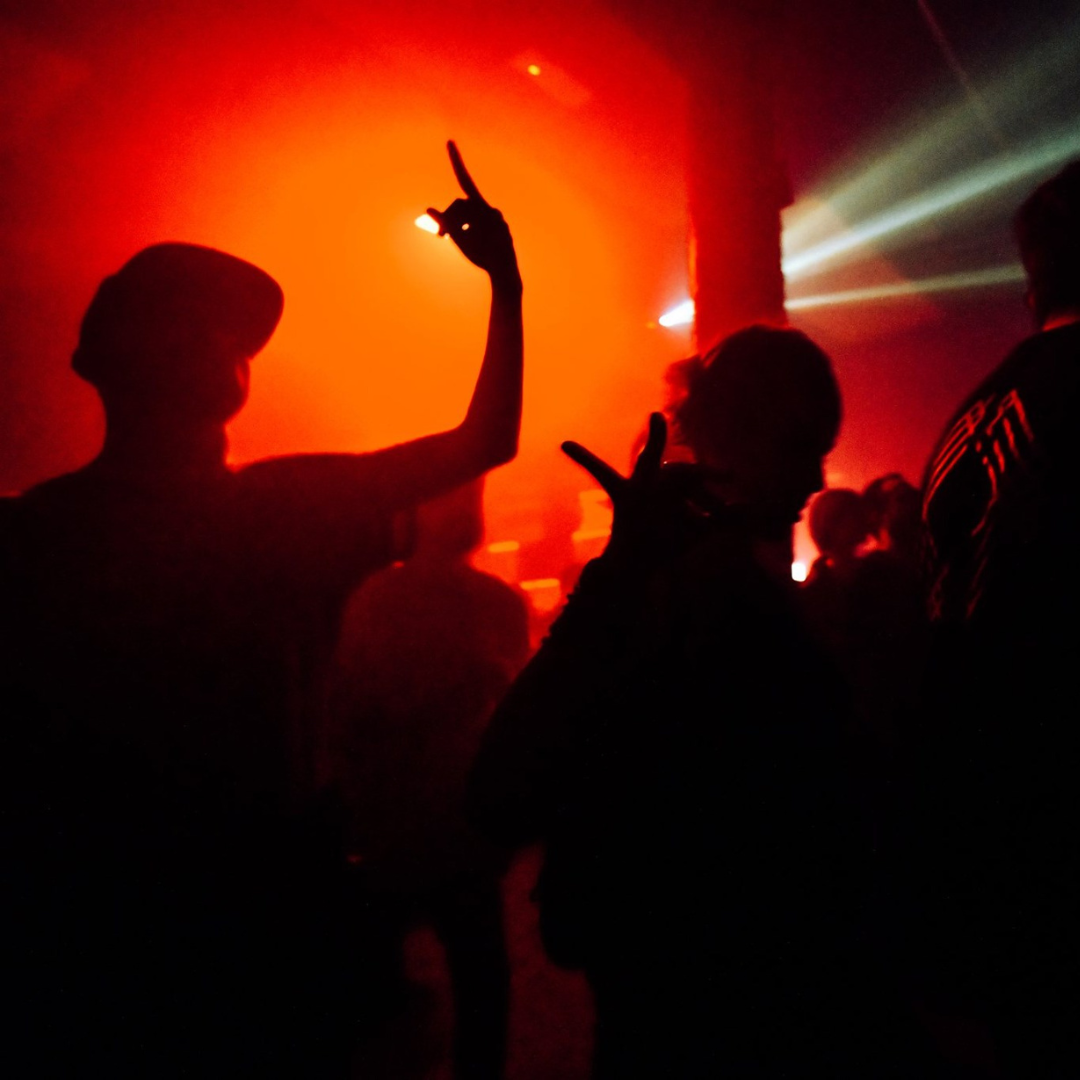 Foto de un evento de música electrónica underground en Barcelona, con DJs locales y público disfrutando de la experiencia.
